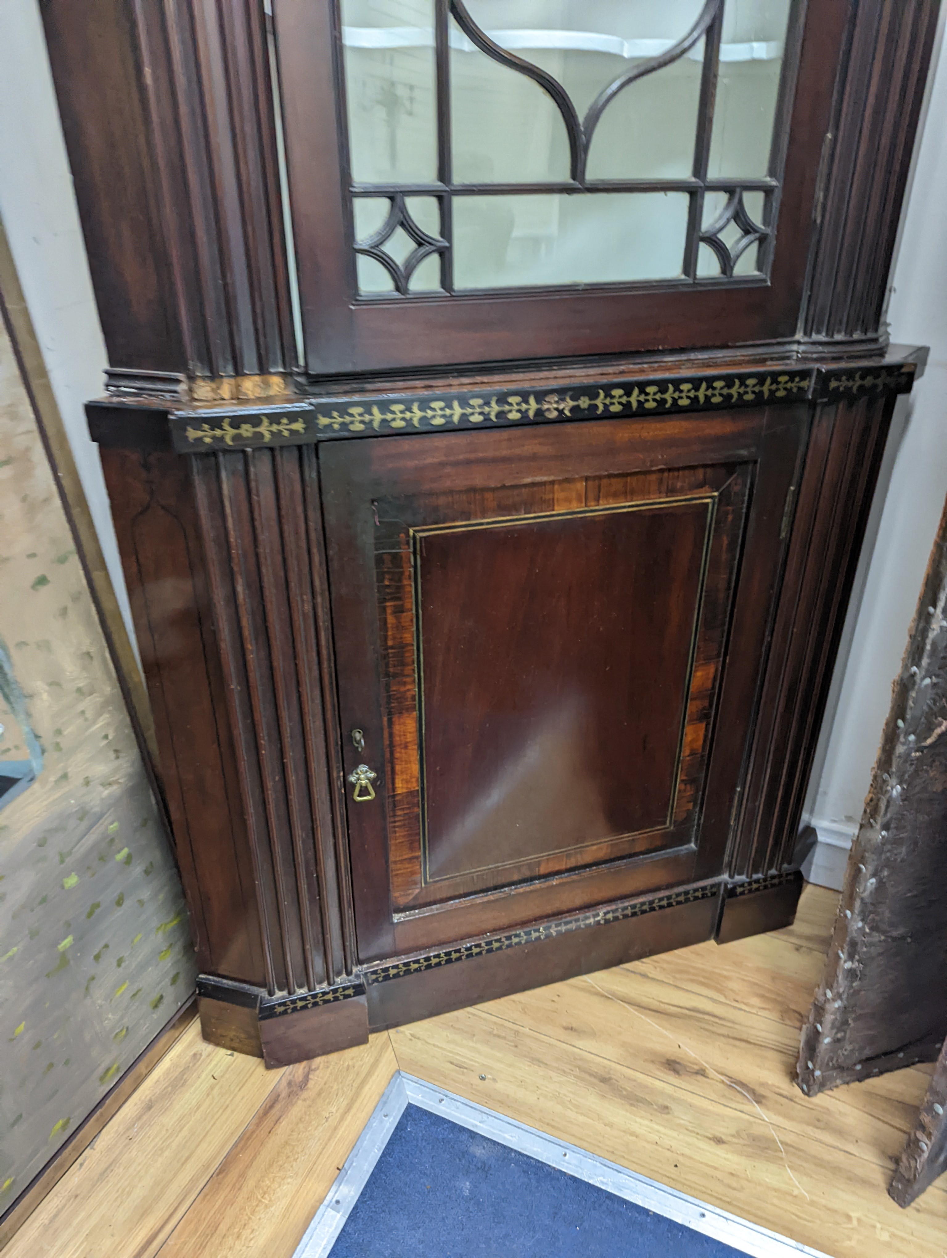 A Regency brass inlaid banded mahogany standing corner cabinet, width 96cm, depth 50cm, height 212cm